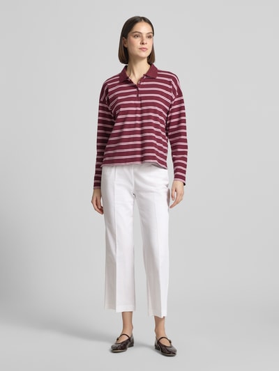 Frauenmodel trägt Wide Fit Stoffhose in 7/8-Länge Modell 'Sue' von TONI aus Baumwoll-Mix mit Bügelfalten und Tunnelzug, Eingrifftaschen, Innenbeinlänge 66 cm, Bundweite 34 cm, Ganzkörperansicht von vorne.