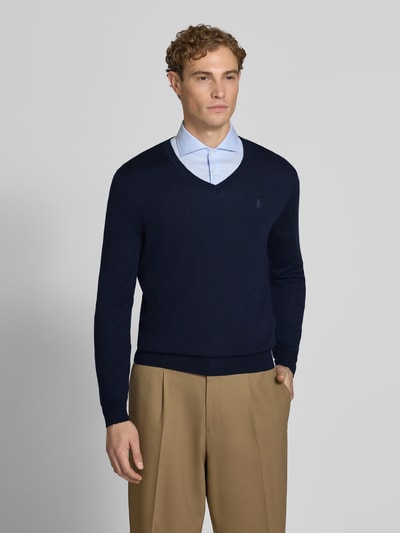 Männermodel trägt Regular Fit Pullover aus reiner Wolle von Polo Ralph Lauren in Dunkelblau, schlichtes Design, Nahaufnahme Oberkörper.