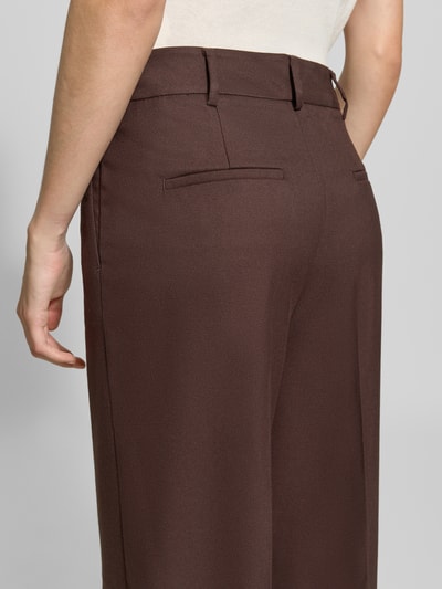 Vrouwenmodel draagt Wide Fit broek met viscose van Christian Berg Woman Selection in bruin, elastische materiaalmix, bandplooibroek, Persplooien, haakjes- en ritssluiting, Bandwijdte maat 36: 46 cm, Binnenbeenlengte maat 36: 85 cm, detailopname rugaanzicht.