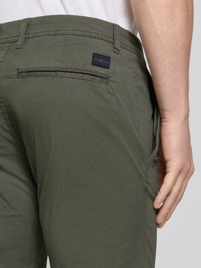 Männermodel trägt Slim Fit Chinoshorts aus Baumwoll-Mix von Tom Tailor, Optik:Allover-Muster, Materialverarbeitung: Twill, Ganzkörperansicht Rückansicht.