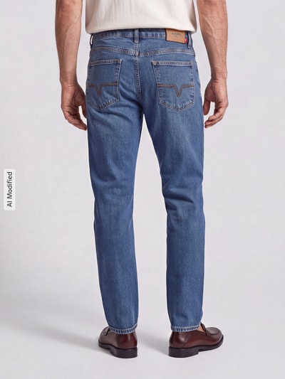 Mężczyzna nosi Modern Fit Straight Fit Jeans aus Baumwoll-Mix Modell 'Mitch' od JOOP!, niebieski denim, proste nogawki, z tyłu, Herren Straight Fit Jeans von JOOP! JEANS, Ganzkörperansicht Rückansicht, KI-modifiziertes Bild