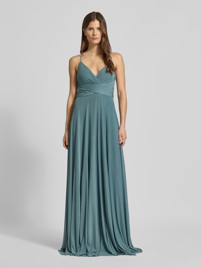 Frauenmodel trägt Maxikleid in Wickel-Optik mit rückseitiger Schnürung von Jake*s Cocktail, A-Linie, Material-Mix mit Stretch-Anteil, Farbe petrol, Ganzkörperansicht von vorne.