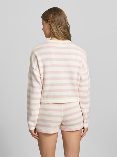 Frauenmodel trägt Boxy Fit Strickpullover mit Streifenmuster und Label-Stitching von Guess Jeans aus Reine Baumwolle, Ganzkörperansicht Rückansicht.