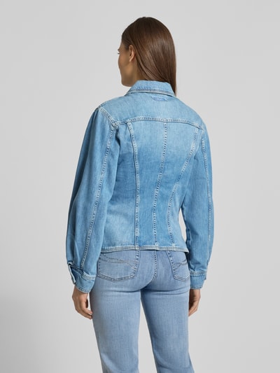 Frauenmodel trägt Regular Fit Jeansjacke mit Brusttaschen von Liu Jo White aus bawełna, krój regular fit, kieszenie na piersi, wykładany kołnierz, listwa guzikowa, sportowe mankiety, taliowany krój, długość tyłu w rozmiarze S 54 cm, szerokość ramion w rozmiarze S 39 cm, szerokość klatki piersiowej w rozmiarze S 42 cm, długość rękawów w rozmiarze S 59 cm, jasnoniebieski kolor, tekstura jeansu, całkowity widok z tyłu.