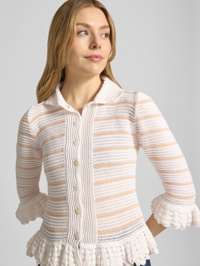 Frauenmodel trägt Strickjacke mit Umlegekragen von Rich & Royal aus Baumwoll-Mix, Slim-Fit, Lochmuster, Rüschen, 3/4-Arm, Nahaufnahme Oberkörper.