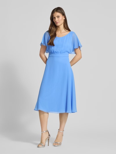 Kobiece modelka nosi Sukienka 'Knielanges Kleid mit Rundhalsausschnitt' od Vera Mont, półprzezroczysty materiał, krój taliowany, okrągły dekolt, wszyty zamek błyskawiczny, krótki rękaw, halka pod spódnicę, długość tyłu w rozmiarze 36: 102 cm, szerokość w rozmiarze 36: 37 cm, długość rękawów w rozmiarze 36: 27 cm, błękitny kolor, gładka faktura, widok całej sylwetki z przodu.