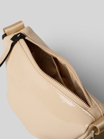 Produktfoto, cremefarbene Handtasche mit Label-Detail Modell 'VALERA' von RAINS, glänzende Oberfläche, Reißverschluss, Schulterriemen, Detailaufnahme.