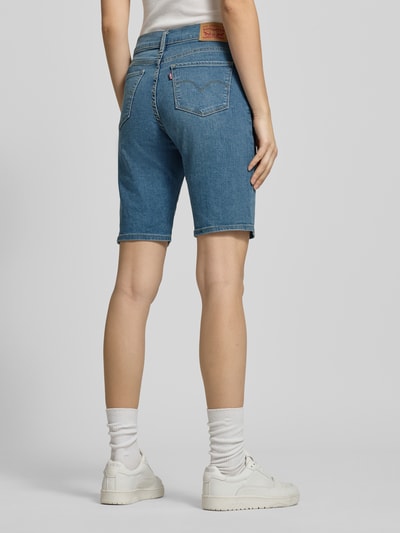 Männermodel trägt Regular Fit Bermuda in Denim-Optik von Levi's®, niebieski bawełniany materiał, 5 kieszeni, szwy widoczne, Ganzkörperansicht Rückansicht.