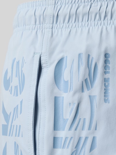 Produktfoto, jasnoniebieskie spodenki kąpielowe z nadrukiem z logo, model 'MAUI WAVE' od Jack & Jones, krój regular fit, elastyczny pas, detal z bliska