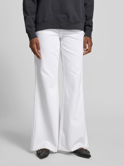Frauenmodel trägt weiße Flared Fit Jeans im 5-Pocket-Design von Anine Bing mit Gürtelschlaufen, Knopf-, Reißverschluss, Nahaufnahme Oberkörper.