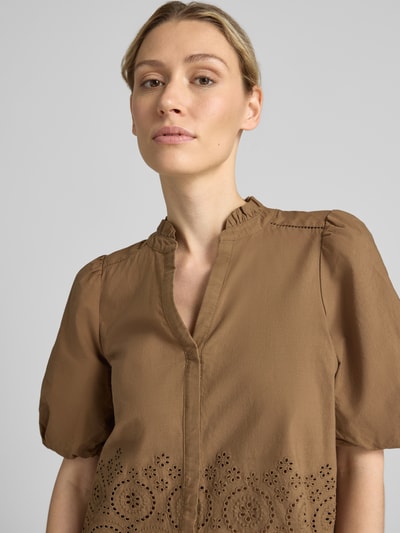 Kobiece modelka nosi Boxy Fit Kurzarmbluse aus reiner Baumwolle von s.Oliver RED LABEL w brązowym kolorze z haftowanymi detalami, zbliżenie na górę ciała