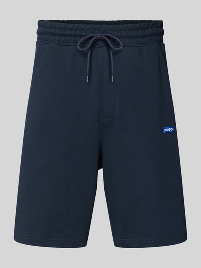 Produktfoto, Regular Fit Sweatshorts aus reiner Baumwolle Modell 'NASENSIO' von Hugo Blue, Optik: Unifarben, Label-Patch, elastischer Bund, Tunnelzug, seitliche Eingrifftaschen, Materialverarbeitung: Sweat, dunkelblauer Farbton, glatte Textur.