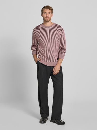Männermodel trägt Strickpullover mit Label-Detail von Paul Smith, Ripp-Optik, Baumwoll-Woll-Mix, taillierte Passform, Ganzkörperansicht von vorne.