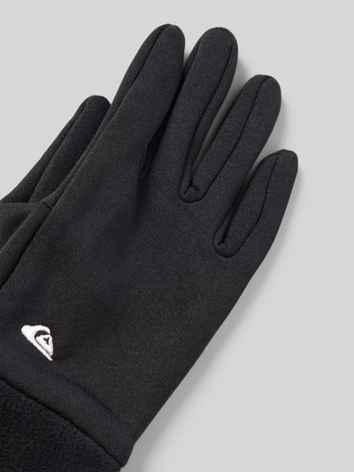 Produktfoto, czarne rękawiczki dziecięce Handschuhe mit Label-Stitching Modell 'HOTTAWA JR' od Quiksilver, materiał polarowy, zbliżenie na detal.