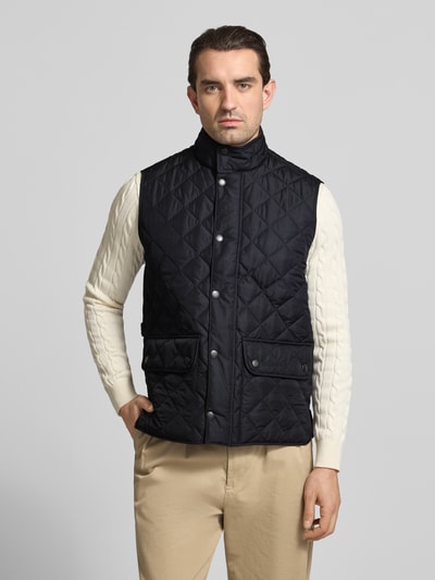 Męski model nosi Regular Fit Steppweste mit Stehkragen von Barbour, jednobarwna, krój regular fit, stójka, pikowanie, przód, ujęcie całej sylwetki.