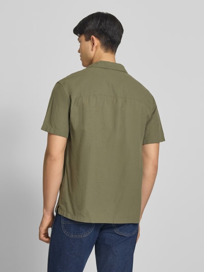 Männermodel trägt Regular Fit Freizeithemd aus Baumwoll-Leinen-Mix von Jack & Jones in Olivgrün, Modell BREEZE, Ganzkörperansicht Rückansicht.