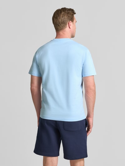 Männermodel trägt Regular Fit T-Shirt aus reiner Baumwolle von Lacoste in Hellblau, glatte Oberfläche, Herren T-Shirt, Ganzkörperansicht Rückansicht.