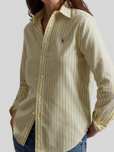 Frauenmodel trägt Regular Fit Hemdbluse aus reiner Baumwolle von Polo Ralph Lauren, gestreiftes Allover-Muster in Gelb und Blau, Logo-Stitching, Nahaufnahme Oberkörper