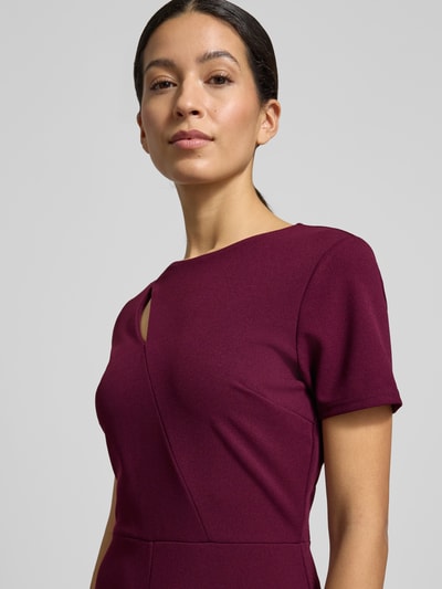 Modelka nosi Regular Fit Jumpsuit mit Cut-Out od Lipsy, elastyczny materiał, krój regular fit, dopasowany w talii, okrągły dekolt, nahtowy zamek, szerokość w rozmiarze 36: 43 cm, długość rękawa: 19 cm, długość całkowita: 146 cm, długość nogawki od wewnątrz: 80 cm, kolor ciemnowinny, gładka faktura, zbliżenie górnej części ciała