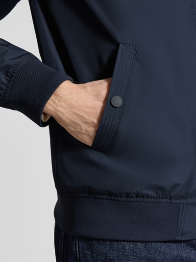 Männermodel trägt Herren Jacke mit Stehkragen Modell 'clay' von Matinique, Regular-Fit, marineblau, Eingrifftaschen mit Druckknopfverschluss, Nahaufnahme Oberkörper.