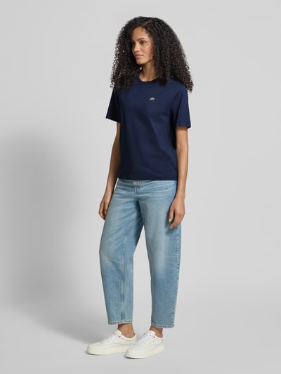 Kobiece modelka nosi Relaxed Fit T-Shirt aus reiner Baumwolle od Lacoste Sport, granatowy, jednolity, logo, okrągły dekolt, bawełna, krótki rękaw. Ganzkörperansicht von vorne.