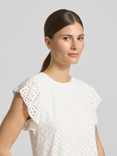 Frauenmodel trägt Regular Fit T-Shirt mit Rundhals-Ausschnitt Modell 'TASSA' von Vero Moda, weiß, Lochmuster, kurzarm, Nahaufnahme Oberkörper.