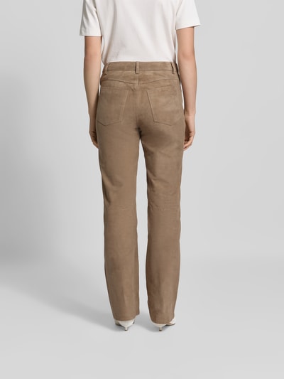 Frauenmodel trägt Stoffhose aus echtem Ziegenvelours von ROTATE, gerade Passform, braun, samtige Textur, Ganzkörperansicht Rückansicht.