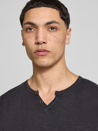 Mannelijk model draagt T-shirt uit puur katoen, recht model, V-hals met knoopsluiting, model 'SPLIT' van Jack & Jones, nahaufnahme bovenlichaam.