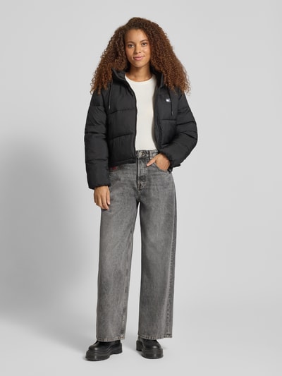Frauenmodel trägt Loose Fit Jeans aus reiner Baumwolle Modell 'CHARLIE' von Tommy Jeans in Grau, Wide Leg, 5-Pocket, Ganzkörperansicht von vorne.