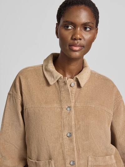 Frauenmodel trägt Relaxed Fit Langarmbluse aus reiner Baumwolle Modell 'JAMIE' von VERO MODA in Beige mit sichtbarer Struktur, Nahaufnahme Oberkörper.