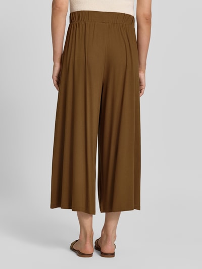 Frauenmodel trägt Wide Leg Culotte aus Viskose-Mix von Armedangels in Braun, glatte Textur, Culotte-Stil, Ganzkörperansicht Rückansicht, Damen Culotte von Armedangels.