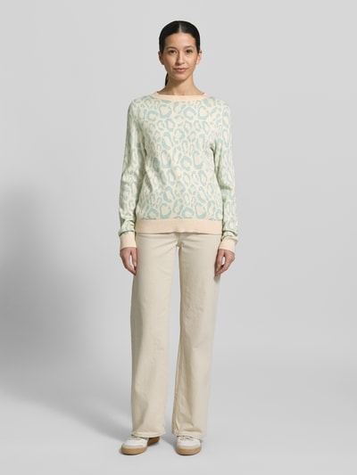Frauenmodel trägt Slim Fit Pullover aus Viskose-Mix Modell 'JACQUARD' von Vila in Strick-Optik mit Allover-Animal-Stitching, cremefarben, Rundhalsausschnitt, elastische Abschlüsse, Rückenlänge 59 cm, Ärmellänge 51 cm, Ganzkörperansicht von vorne.