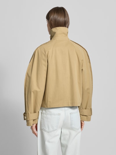 Vrouwenmodel draagt trenchcoat met mouwsluitingen model 'MIA' van Topshop, puur katoen, regular fit, rugaanzicht, detailopname.