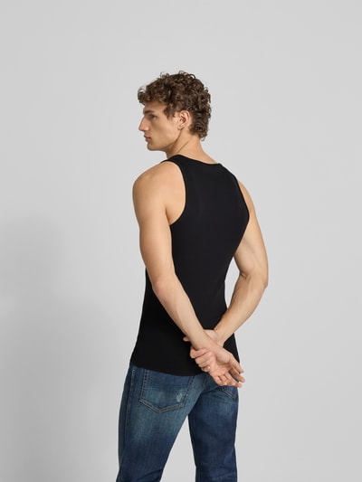 Männermodel trägt schwarzes Tanktop mit Label-Stitching von Diesel aus Baumwoll-Elasthan-Mix, Slim-Fit, Rückenlänge 68 cm, Ganzkörperansicht Rückansicht.