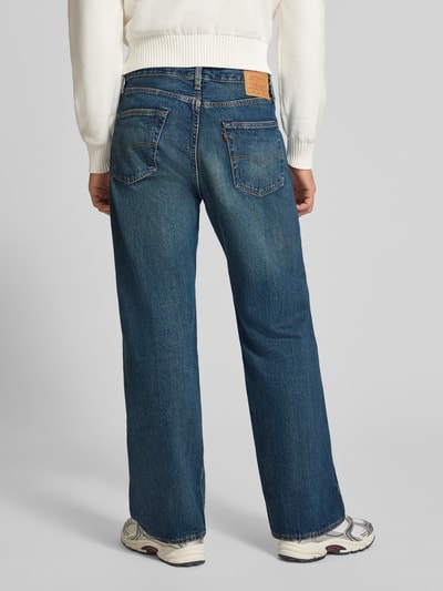 Männermodel trägt blaue Loose Fit Jeans aus reiner Baumwolle Modell '501®' von Levi's®, robuste Textur, Ganzkörperansicht Rückansicht, Herren Wide & Loose Fit Jeans von Levi's®.