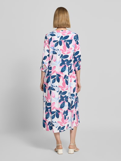 Frauenmodel trägt Midikleid aus Viskose mit 3/4-Arm Modell 'Ma44ilin' von ZABAIONE mit Allover-Blattmuster in Rosa, Blau, Weiß, gerader Schnitt, Rundhalsausschnitt, Knopfleiste, Rückenlänge 115 cm, Brustweite 51 cm, Ärmellänge 42 cm, Ganzkörperansicht Rückansicht.