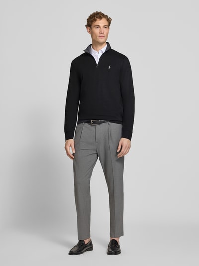 Männermodel trägt Regular Fit Sweatshirt aus Baumwoll-Mix von Polo Ralph Lauren in Schwarz, kombiniert mit grauer Hose, Ganzkörperansicht von vorne. Herren Sweatshirt von Polo Ralph Lauren