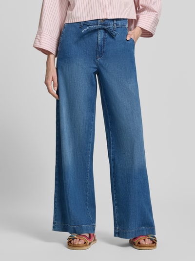 Kobiece modelka nosi Wide Leg Jeans mit Bindegürtel Modell 'WENDY' von MAC, mieszanka bawełny i elastanu, niebieski kolor, szerokość w rozmiarze 36/32: 43 cm, długość wewnętrzna nogawki w rozmiarze 36/32: 82 cm, widok całej sylwetki z przodu.