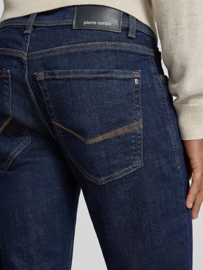 Männermodel draagt Tapered Fit Jeans im 5-Pocket-Design Modell 'Lyon' van Pierre Cardin, donkerblauw, detailopname achterkant, katoenmix met stretch.