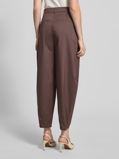 Frauenmodel trägt Stoffhose mit französischen Eingrifftaschen von Christian Berg Woman Selection, braun, Barrel Fit, Ganzkörperansicht Rückansicht.