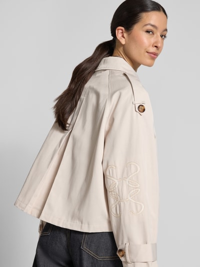 Frauenmodel trägt Kurzer Trenchcoat mit Eingrifftaschen von Smith and Soul, Baumwoll-Mix, kurze Passform, Zweireiher, Umlegekragen, Detailaufnahme Rückansicht.