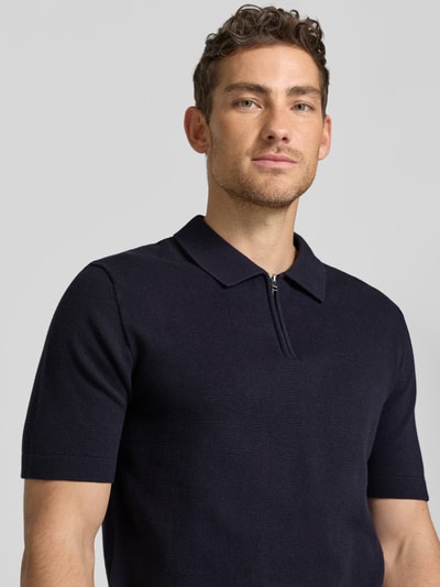Männermodel trägt Regular Fit Poloshirt mit Reißverschluss Modell 'MILANO' von Jack & Jones Premium aus Bio-Baumwoll-Mix, Nahaufnahme Oberkörper.