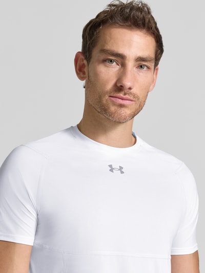 Männermodel trägt T-Shirt mit Logo-Print und Raglanärmel van Under Armour in wit Materiaalmix met stretch, ronde hals, logoprint, nahaufnahme oberkörper