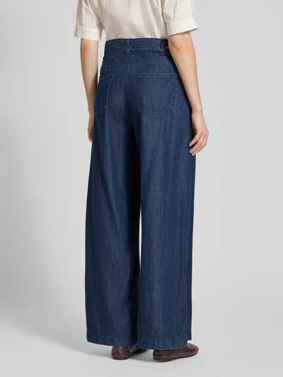 Frauenmodel trägt Wide Leg Jeans mit Bindegürtel Modell 'Wendy' von MAC aus Baumwoll-Lyocell-Mix in Dunkelblau, Ganzkörperansicht Rückansicht.