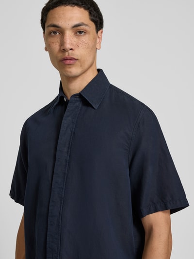 Männermodel trägt Relaxed Fit Leinenhemd mit Kentkragen von Filippa K in Dunkelblau, Baumwoll-Leinen-Mix, Nahaufnahme Oberkörper.