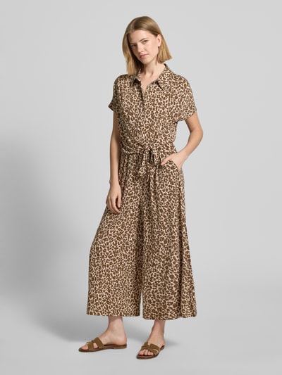 Frauenmodel trägt Jumpsuit mit Allover-Animal-Print von Betty Barclay im Elastischer-Material-Mix, Tailliert, Umlegekragen, Knopfleiste, Kurzärmelig, in Braun- und Beigetönen mit weiten Hosenbeinen, Gesamtlänge 121 cm, Ganzkörperansicht von vorne.