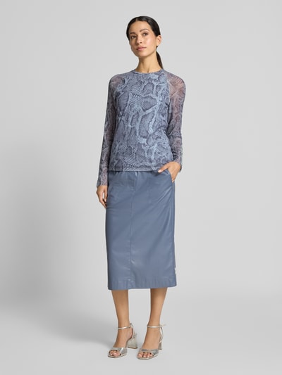 Frauenmodel trägt Longsleeve aus Mesh mit Schlangen-Muster von Marc Cain in Blau, körpernaher Schnitt, semitransparente Ärmel, Material-Mix mit Stretch-Anteil, kombiniert mit Midi-Rock, Ganzkörperansicht von vorne.