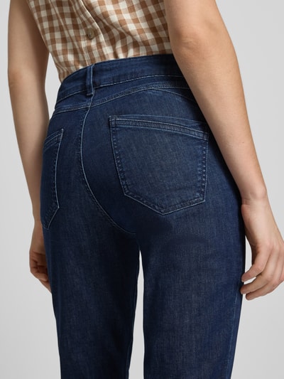 Frauenmodel trägt Slim Fit Jeans aus Baumwoll-Mix Modell 'SHAKIRA' von Brax in Denim-Optik, Label-Patch, Gürtelschlaufen, Detailaufnahme Rückansicht.