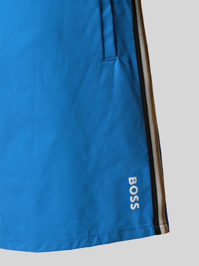 Produktfoto, Badeshorts mit Tunnelzug Modell 'ICONIC' von BOSS in Blau, Optik: Unifarben, Label-Print, Kontraststreifen, seitliche Eingrifftaschen, Gesäßtasche, elastischer Bundabschluss