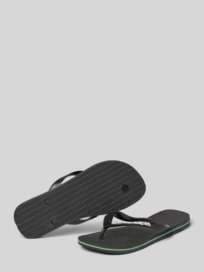 Produktfoto, Slippers mit Logo-Detail Modell 'Brasil' von Havaianas in Schwarz mit abgerundeter Passform, offener Ferse, 2 cm Absatz, strukturierter Sohle und grün-gelbem Akzent, Damen Slippers